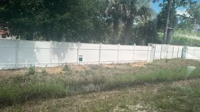 a white fence in front of a field at Ocean View Habana in Hialeah