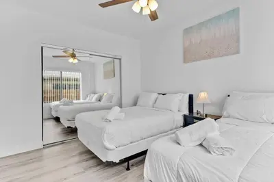 a white room with four beds and a couch at Comfy Apt 5 min walking to Design District apt 4 in Miami