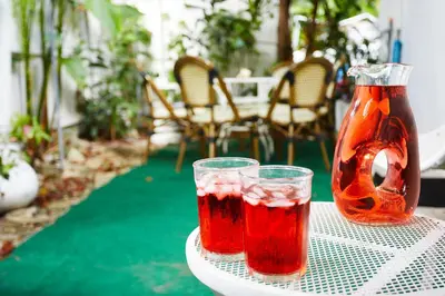 two drinks on a table with a vase at Miami Pool Cottage, tropical garden paradise in Miami