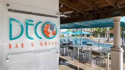 a sign for a bar and grill next to a pool at Marriott Villas at Doral 2BD sleeps 8 in Miami