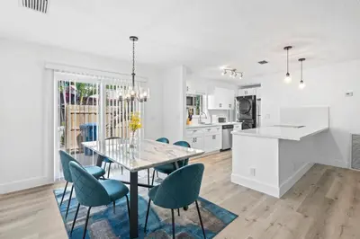 a kitchen and dining room with a glass table and chairs at Weekly Discounts 10 min to Beach by TilahStays in Fort Lauderdale