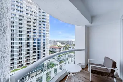 a room with a balcony with a view of a building at Stylish Oceanview Apartment Prime Location in Fort Lauderdale