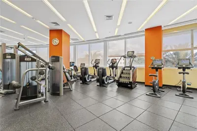 a gym with several treadmills and cardio machines at Ocean View Luxurious Studio Premium Amenities in Sunny Isles Beach