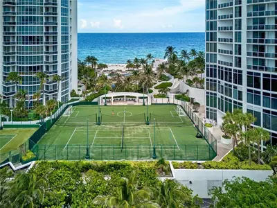 an aerial view of a tennis court in front of the ocean at Ocean View Luxurious Studio Premium Amenities in Sunny Isles Beach