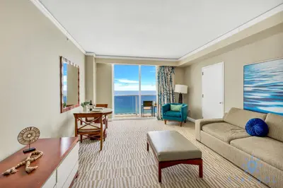 a living room with a couch and a table at Ocean View Luxurious Studio Premium Amenities in Sunny Isles Beach