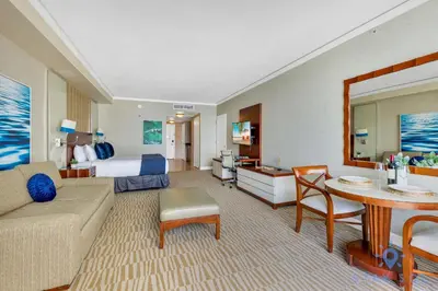 a large hotel room with a bed and a living room at Ocean View Luxurious Studio Premium Amenities in Sunny Isles Beach