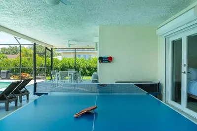 a ping pong table in a living room at Waterfront Pool & Amazing Location - WOW in Miami