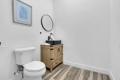 a bathroom with a toilet and a mirror on the wall at Spacious Retreat with Green Areas 8 ppl in Miami
