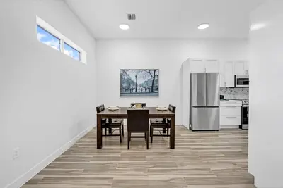 a kitchen with a dining table and a refrigerator at Spacious Retreat with Green Areas 8 ppl in Miami