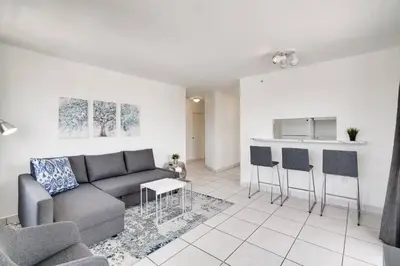 a living room with a couch and a kitchen at 1106- 1BR & 1BA with Balcony, Stunning City & Ocean Views in Miami Beach