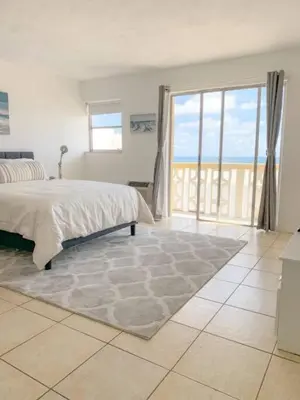 a bedroom with a bed and a large window at 1402- Oceanfront 1BR & 1 Bath Retreat with Stunning Views in Miami Beach