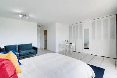 a bedroom with a bed and a couch and a table at 1405- South Beach 1BR & 1BA- Stunning Ocean View Oasis in Miami Beach