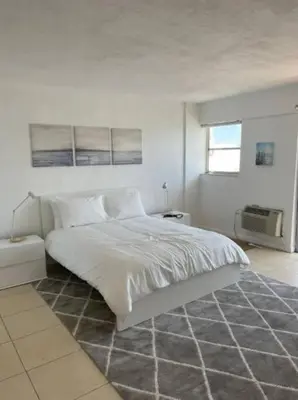 a white bedroom with a large bed and a window at 1502- Seaside Serenity- 1BR & 1BA, Ocean Views in Miami Beach
