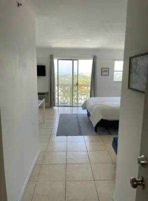 a view of a bedroom with a bed and a balcony at 1505- Downtown Miami Bay View Retreat with 1BR & 1BA in Miami Beach