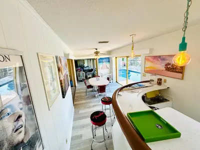 a kitchen with a sink and a table with chairs at Fort Lauderdale Beach Oasis in Fort Lauderdale