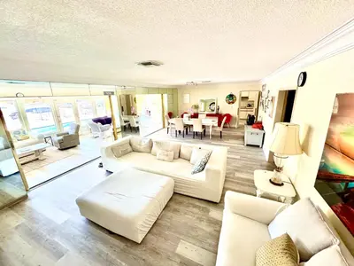 a living room with white furniture and a dining room at Fort Lauderdale Beach Oasis in Fort Lauderdale