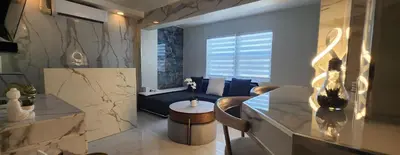 a living room with a couch and a table at Luxurious Waterfront 2 room apartment- Remodeled- Free parking- 5min drive to Miami Beach in Miami Beach