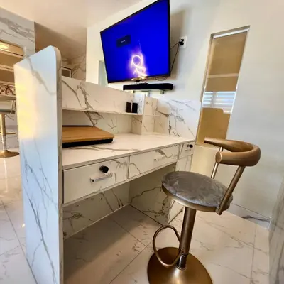 a desk with a monitor and a chair in a room at Luxurious Waterfront 2 room apartment- Remodeled- Free parking- 5min drive to Miami Beach in Miami Beach
