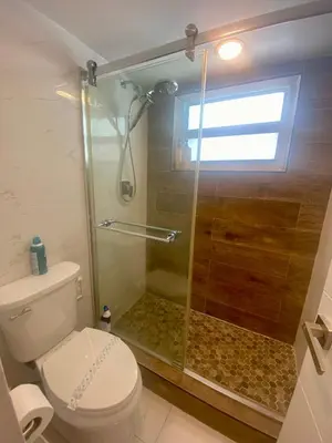 a bathroom with a shower and a toilet at Luxurious Waterfront 2 room apartment- Remodeled- Free parking- 5min drive to Miami Beach in Miami Beach