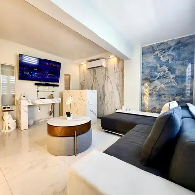 a living room with a couch and a table at Luxurious Waterfront 2 room apartment- Remodeled- Free parking- 5min drive to Miami Beach in Miami Beach