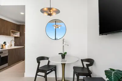 a dining room with a table and chairs and a mirror at 5108Great Penthouse, Bay view, in the heart of MIAMI in Miami