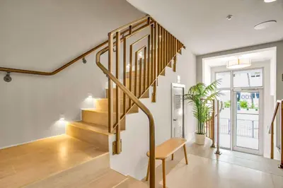a staircase in a living room with a wooden bench at Vonder Miami Beach - Unit 1 in Miami Beach