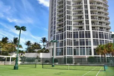 a tennis court in front of a tall building at Luxury Bayfront Studio with Balcony Amazing Pool in Sunny Isles Beach