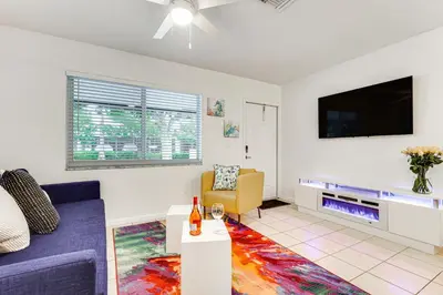 a living room with a couch and a tv at 2 Mi to Dtwn Hollywood Vibrant Pet-Friendly Condo in Hallandale Beach