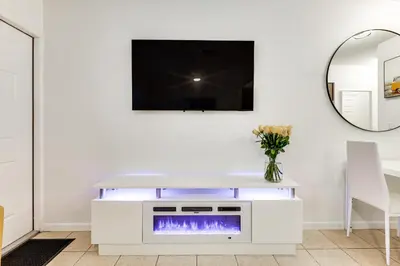 a living room with a tv and a fireplace at 2 Mi to Dtwn Hollywood Vibrant Pet-Friendly Condo in Hallandale Beach