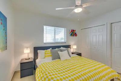 a bedroom with a yellow bed with two night stands at 2 Mi to Ocean Dog-Friendly Hallandale Beach Condo in Hallandale Beach