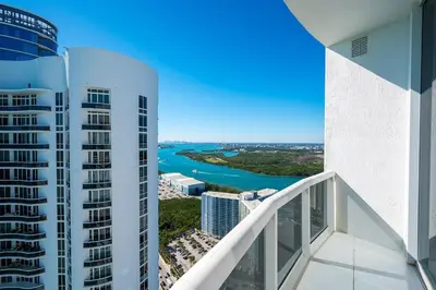 a balcony with a view of a river and buildings at Sophisticated Modern Gem with Unreal Ocean Views in Sunny Isles Beach
