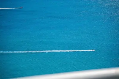 a boat in the middle of the ocean at Sophisticated Modern Gem with Unreal Ocean Views in Sunny Isles Beach