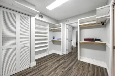 a walk in closet with white closets and wood floors at Luxurious Hollywood Retreat Perfect Getaway in Hollywood
