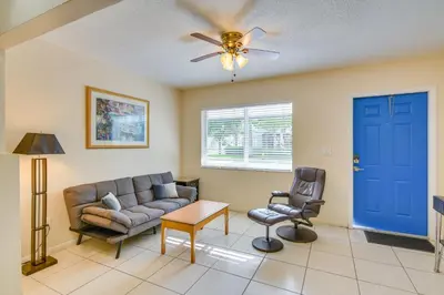 a living room with a couch and a chair at Pet-Friendly Hallandale Beach Condo Near Boardwalk in Hallandale Beach