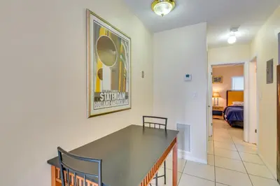 a dining room with a table and a bedroom at Pet-Friendly Hallandale Beach Condo Near Boardwalk in Hallandale Beach