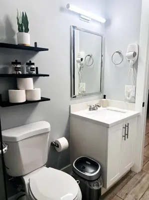 a bathroom with a white toilet and a sink at Private Double Room Near Miami Clinics in Miami