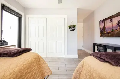 a bedroom with two beds and a white door at Private Double Room Near Miami Clinics in Miami