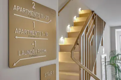 a stairway arrow sign on a wall in a hallway at Vonder Miami Beach - Unit 2 in Miami Beach