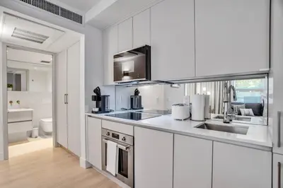 a kitchen with white cabinets and a sink at Vonder Miami Beach - Unit 4 in Miami Beach