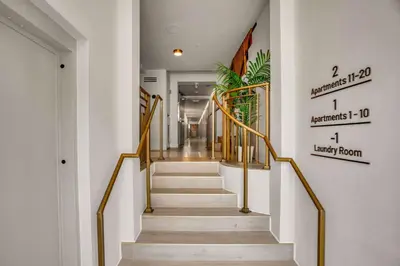 a staircase with gold railings in a hallway at Vonder Miami Beach - Unit 5 in Miami Beach