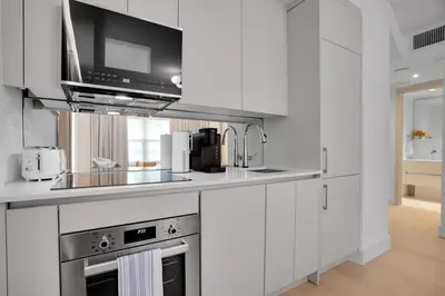 a kitchen with white cabinets and a microwave at Vonder Miami Beach - Unit 5 in Miami Beach