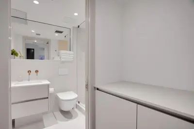 a white bathroom with a toilet and a sink at Vonder Miami Beach - Unit 5 in Miami Beach