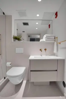 a white bathroom with a toilet and a sink at Vonder Miami Beach - Unit 8 in Miami Beach