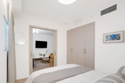 a white bedroom with a bed and a mirror at Vonder Miami Beach - Unit 7 in Miami Beach