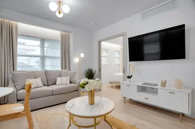 a living room with a couch and a tv at Vonder Miami Beach - Unit 10 in Miami Beach