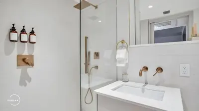 a white bathroom with a sink and a mirror at Vonder Miami Beach - Unit 10 in Miami Beach