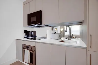 a white kitchen with a sink and a microwave at Vonder Miami Beach - Unit 11 in Miami Beach