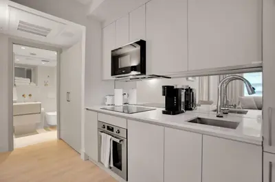 a white kitchen with a sink and a microwave at Vonder Miami Beach - Unit 12 in Miami Beach