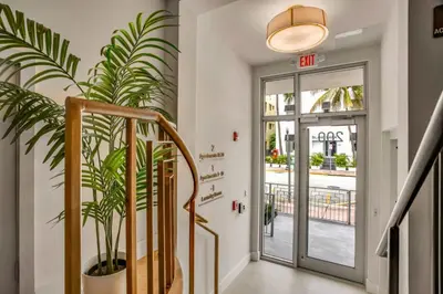 a staircase with a potted plant next to a door at Vonder Miami Beach - Unit 18 in Miami Beach