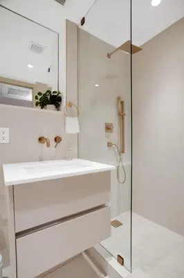 a white bathroom with a sink and a shower at Vonder Miami Beach - Unit 17 in Miami Beach